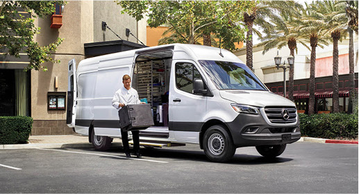 Technician unloading equipment from a Mercedes-Benz Sprinter Cargo Van.