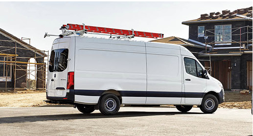 Side view of a Mercedes-Benz Sprinter Cargo Van with ladder rack.