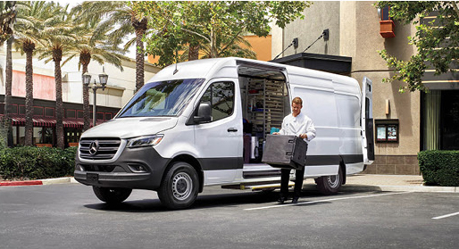 Technician unloading equipment from a Mercedes-Benz Sprinter Cargo Van.