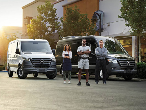 Business owners standing in front of Mercedes-Benz Sprinter commercial vans.