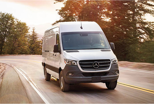 Mercedes-Benz Sprinter Cargo Van driving on a winding road.