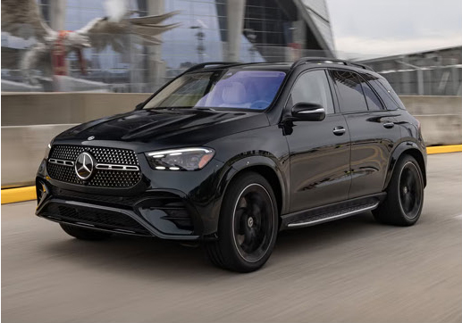 Black Mercedes-Benz GLE SUV driving through an urban setting.