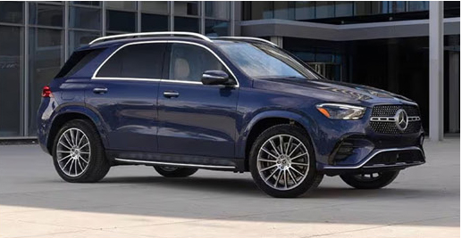 Blue Mercedes-Benz GLE SUV parked outside a modern building.