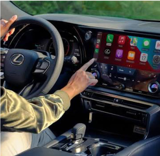 Driver using Apple CarPlay in a Lexus RX luxury SUV.