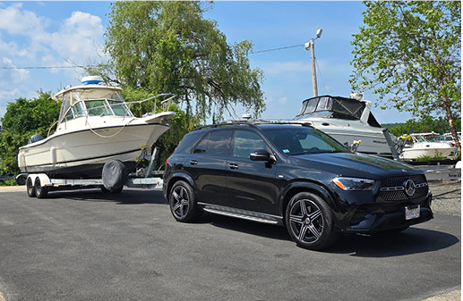 Mercedes-Benz GLE SUV towing a boat trailer.