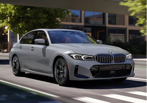 Gray BMW 3 Series luxury sedan driving through the city