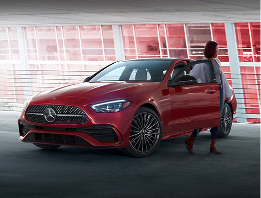 Red Mercedes-Benz C-Class sedan with driver exiting the vehicle