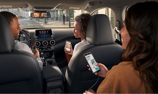 Nissan Sentra interior with passengers using smartphones and connected technology