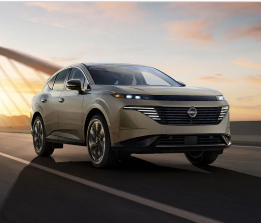 Nissan Murano SUV driving across a bridge at sunset