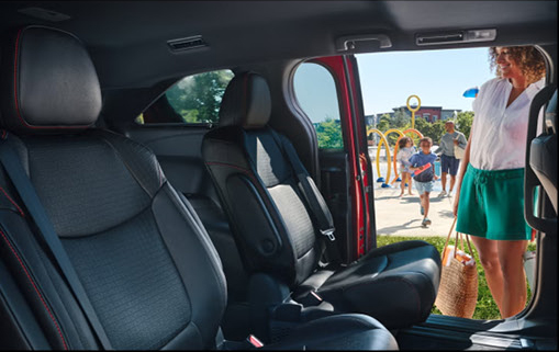 Toyota Sienna minivan with second-row captain's chairs and family-friendly interior featuring easy passenger access through the sliding door.
