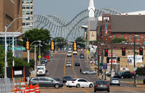 Downtown Memphis street view featuring the Hernando de Soto Bridge, city traffic and the Memphis skyline along Danny Thomas Boulevard.
