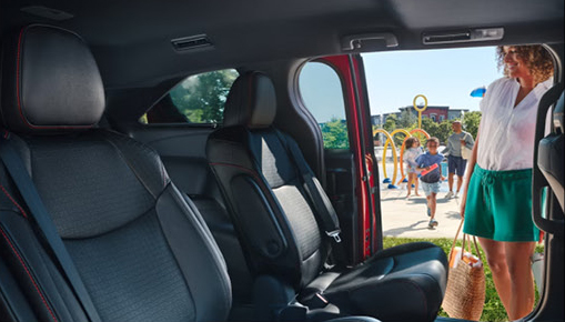 Toyota Sienna interior with second-row captain's chairs and family-friendly sliding door access at a neighborhood park.