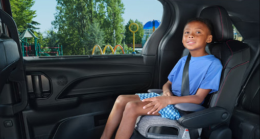 Child secured in a child safety seat inside the Toyota Sienna showcasing rear-seat comfort and family-focused safety.