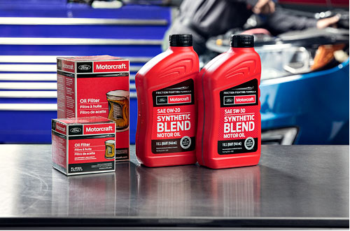 Motorcraft full synthetic motor oil bottles and oil filters on a Ford service counter