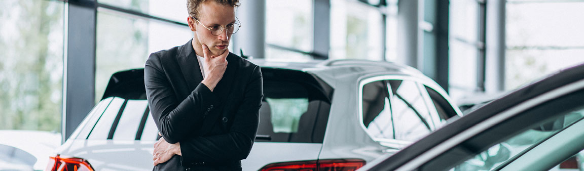 Man looking at car in showroom