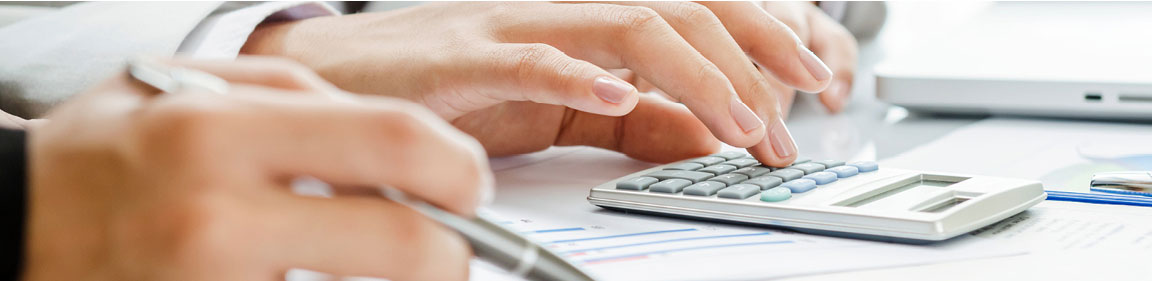 Hands using calculator at desk