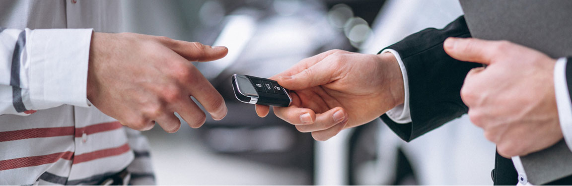 Hands exchanging car keys