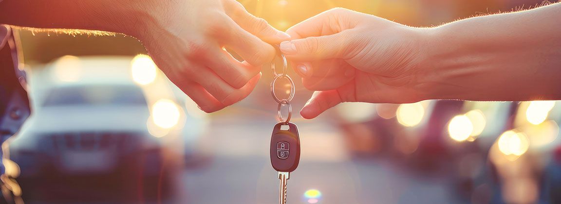 Customer receiving car keys during a vehicle purchase at a dealership