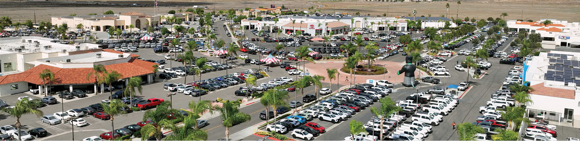 Aerial view of a large auto dealership complex with new and used vehicle inventory across multiple lots