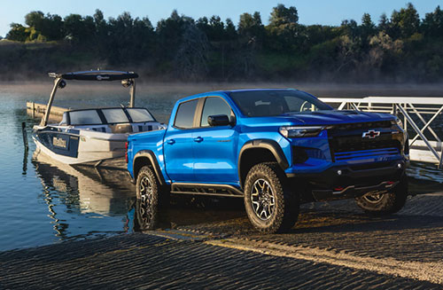 Chevrolet Colorado off-road pickup truck launching a boat at a lakeside ramp