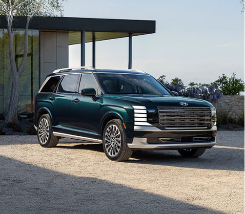 Hyundai Palisade three-row SUV parked outside a modern home