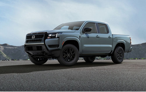 Nissan Frontier truck parked with mountain backdrop