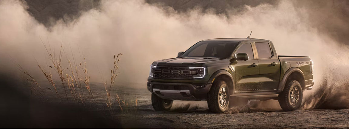 Ford Ranger Raptor truck kicking up dust off-road