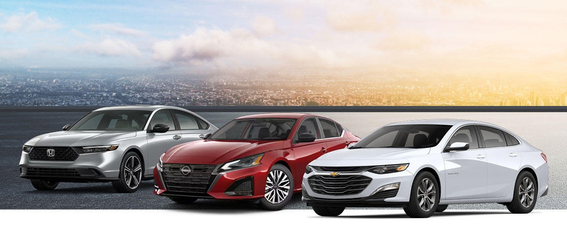 Silver Honda Accord, red Nissan Altima, and white Chevrolet Malibu sedans side by side