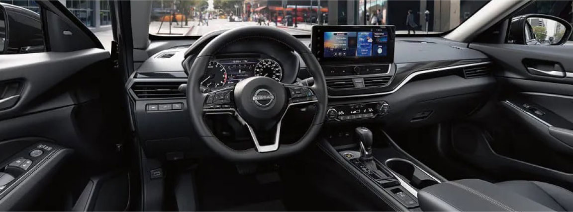 Nissan Altima interior with steering wheel and touchscreen display