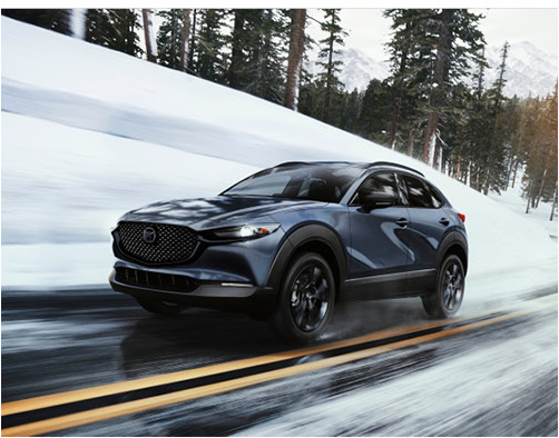 Mazda CX-30 driving on a snowy mountain road