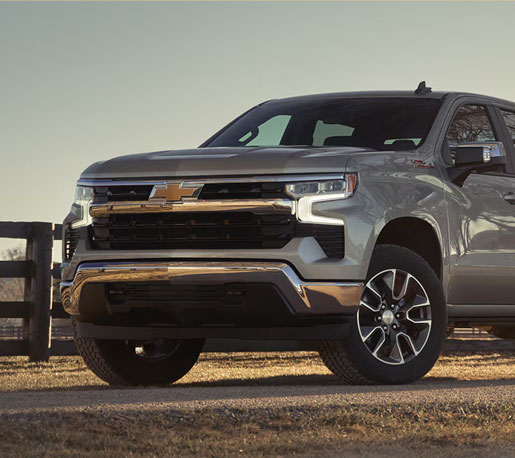 Silver Chevrolet Silverado pickup truck in an outdoor rural setting