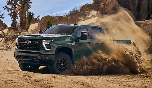 Green truck in sand